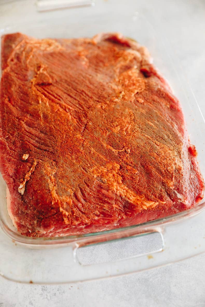 Dry brined brisket in a baking dish.