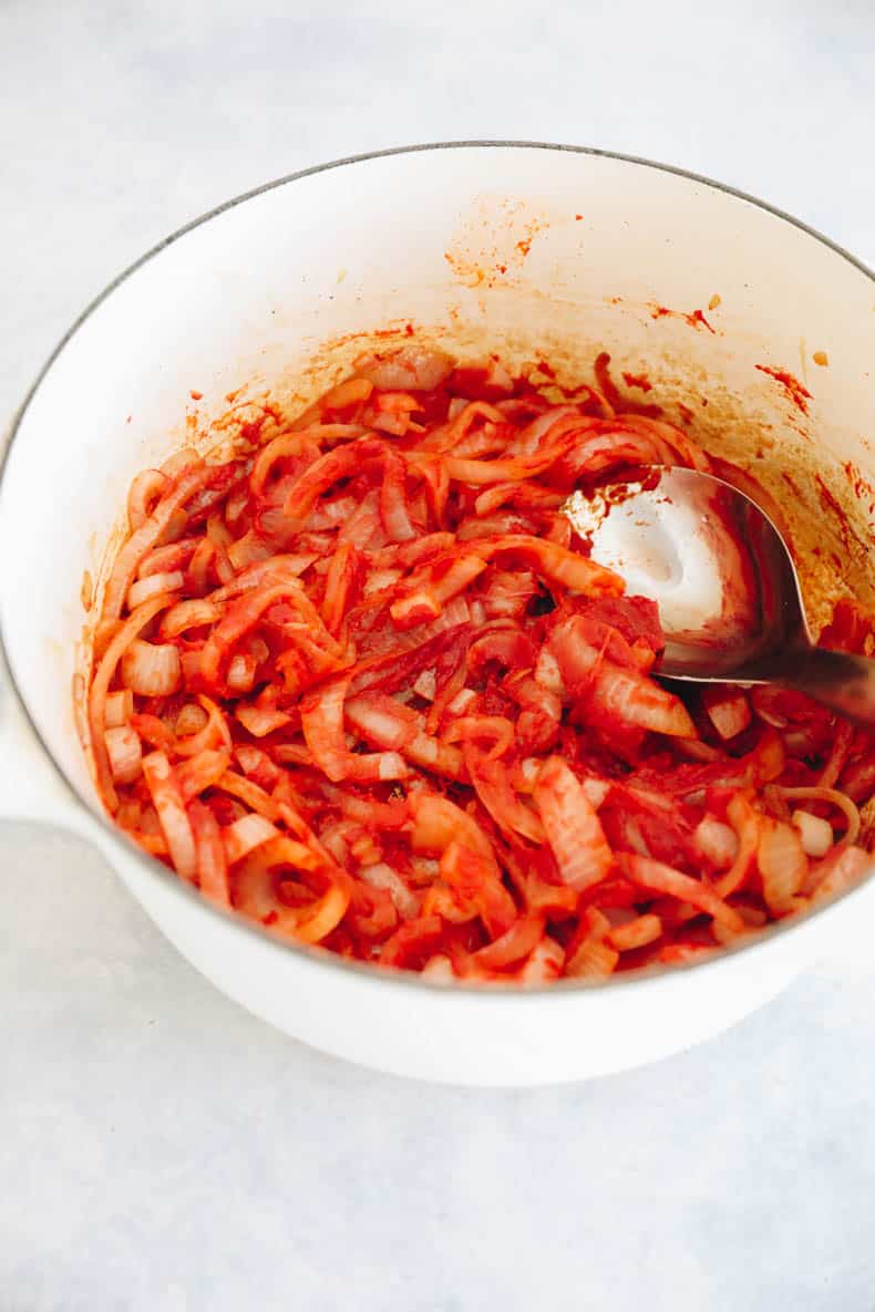 caramelized onions and tomato paste in a dutch oven