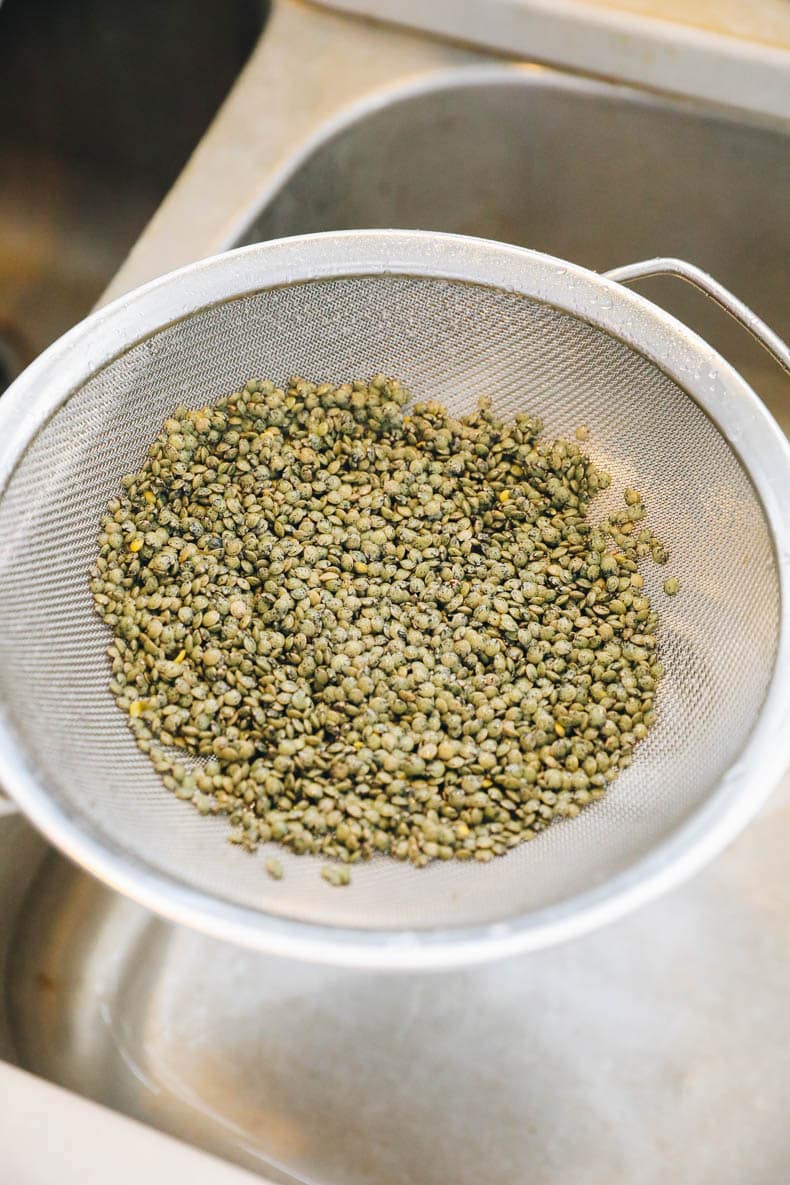 French lentils rinsed in a strainer.