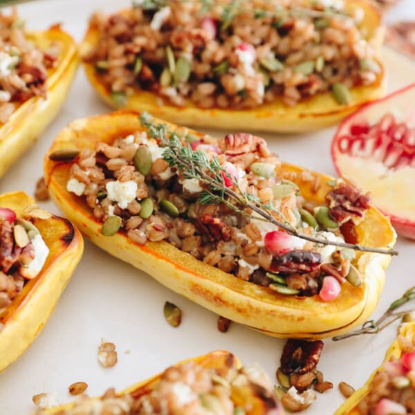 stuffed delicata squashes with farro, pomegranate seeds, pumpkin seeds, pecans and goat cheese.