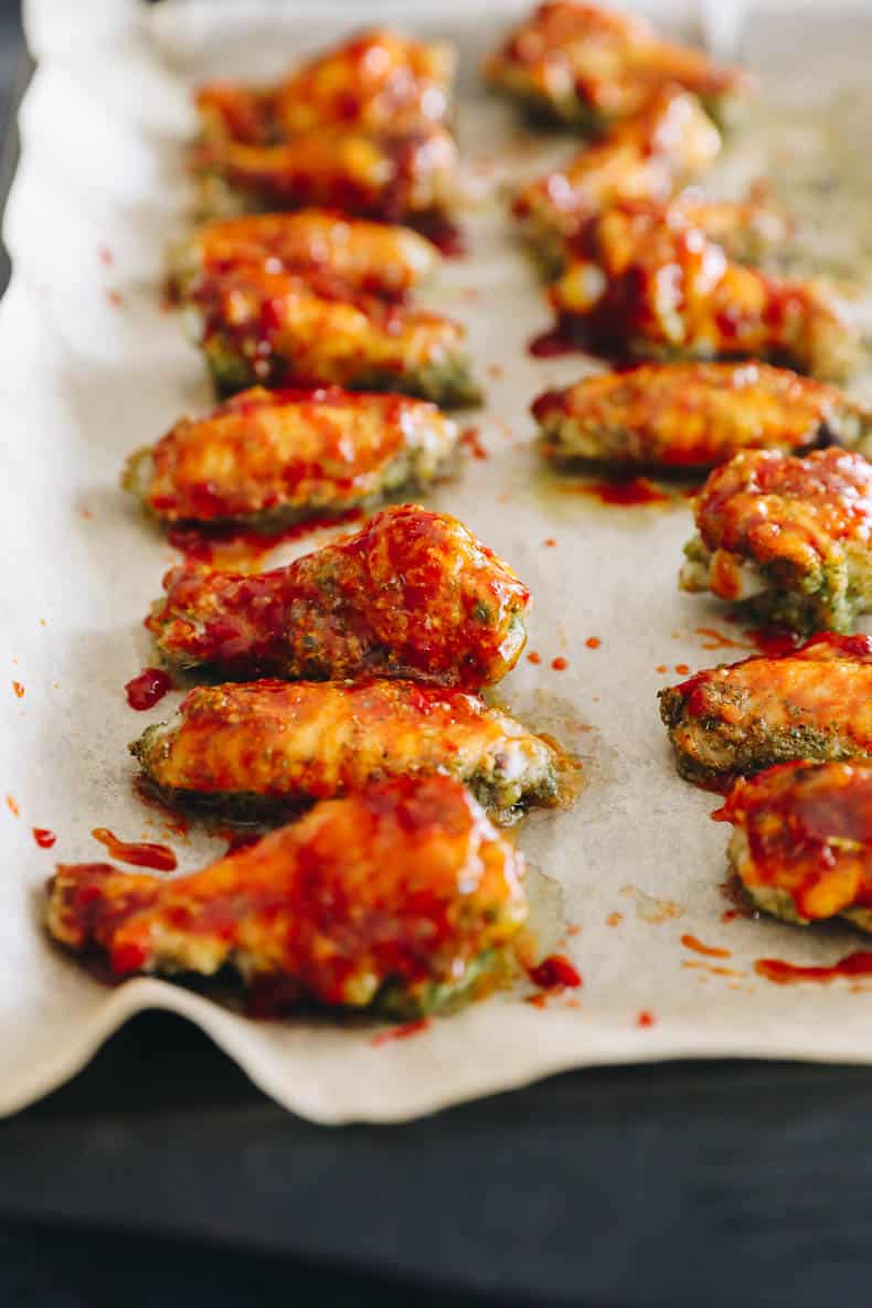 baked thai basil wings on a sheet pan lined with parchment.